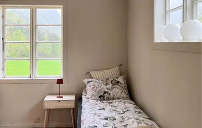 a bedroom with a bed and two windows at Gorgeous Home In Eikesdal - N28170 in Verma