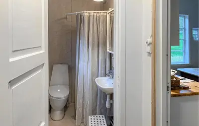 a bathroom with a white toilet and a sink at Gorgeous Home In Eikesdal - N28170 in Verma