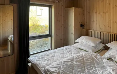 a bedroom with a large bed and a window at 2 Bedroom Beautiful Home In Gålå in Gålå