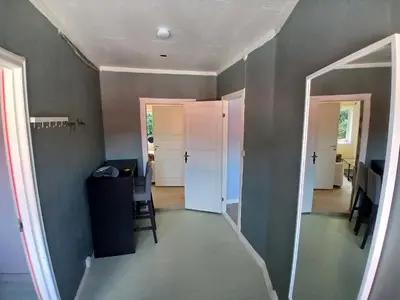 a hallway with a door and a table and chairs at 2 Bedroom central apartment in Bergen