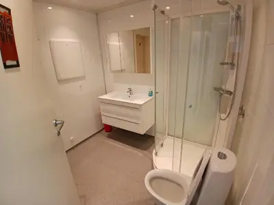 a bathroom with a shower and a toilet and a sink at 2 Bedroom central apartment in Bergen