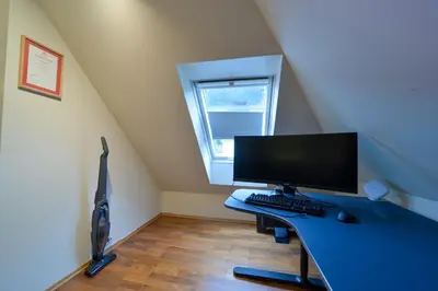 an office with a desk with a computer on it at Penthouse in Bergen