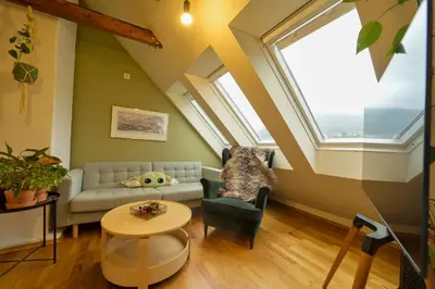 a living room with a couch and a table at Penthouse in Bergen
