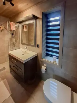 a bathroom with a sink and a toilet and a window at Modern Cabin In Norefjell With Sauna in Noresund