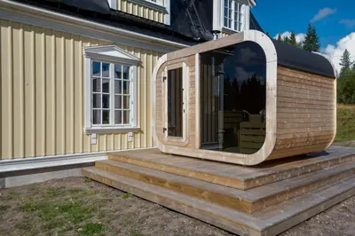 a dog house with a large window on the side of a house at Villa Grøndalen Gård in Trysil