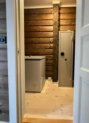 a hallway with a door leading to a room with wood at Mountain Cabin With Great Ski Terrain in Vingelen