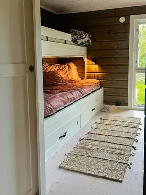 a bedroom with a bunk bed in a room with a rug at Mountain Cabin With Great Ski Terrain in Vingelen