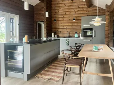 a kitchen with a table and a dining room at Mountain Cabin With Great Ski Terrain in Vingelen