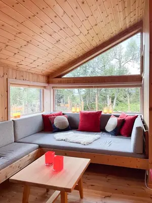 a large couch in a room with a window at Modernized Log Cabin At Ljøsheim in Sjusjøen