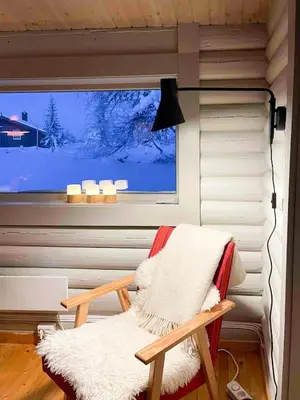 a room with a chair in front of a window at Modernized Log Cabin At Ljøsheim in Sjusjøen