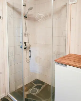 a shower with a glass door in a bathroom at Spacious Family Cabin With Views In Hafjell in Øyer