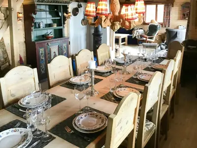 a long table with glasses and plates on it at Spacious Family Cabin With Views In Hafjell in Øyer