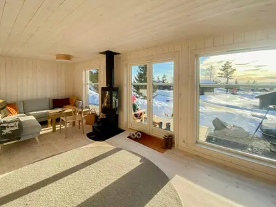 a living room with a couch and a large window at Family Cabin With Views In Lygnalia in Jaren