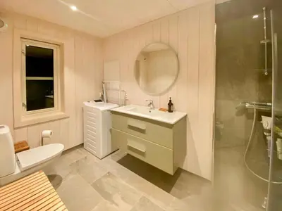 a bathroom with a sink and a toilet and a shower at Family Cabin With Views In Lygnalia in Jaren