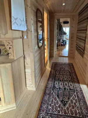 a hallway of a house with a rug on the floor at Authentic Cabin Overlooking Lake Møsvann in Rjukan