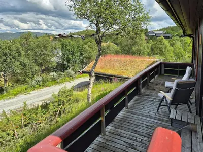 a balcony with chairs and a view of a road at Authentic Cabin Overlooking Lake Møsvann in Rjukan