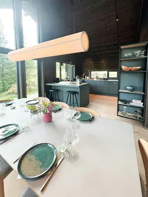a dining room with a table with plates and glasses at Mountain Cabin With Beautiful Lake View in Hemsedal