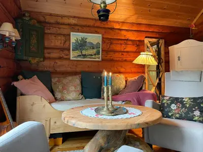 a living room with a table with a candle on it at Traditional Log Cabin By Lake Seljord in Seljord