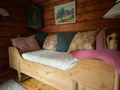 a bed in a log cabin with pillows on it at Traditional Log Cabin By Lake Seljord in Seljord