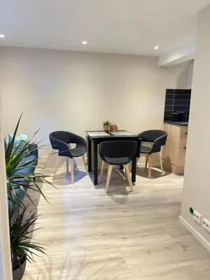 a dining room with a black table and chairs at Free parking grand floor Apartment in Ålesund in Ålesund