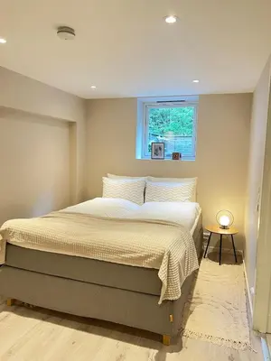 a bedroom with a large bed with a window at Free parking grand floor Apartment in Ålesund in Ålesund