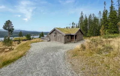 a cabin on a hill with a gravel road at Lovely Home In Gålå With Sauna in Gålå