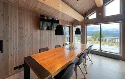 a dining room with a wooden table and chairs at Lovely Home In Gålå With Sauna in Gålå