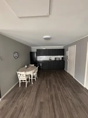 a dining room and kitchen with a table and chairs at Steinkjer, 5 room apartment in Steinkjer
