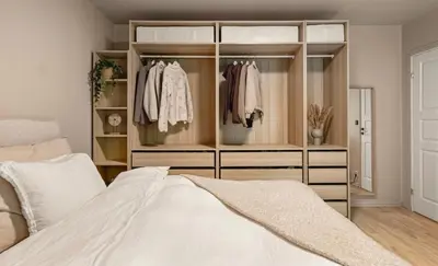 a bedroom with a bed and a closet at Solheimslien in Bergen