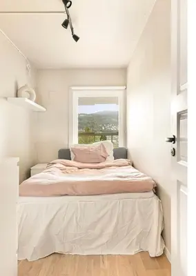 a bed in a room with a window at Solheimslien in Bergen