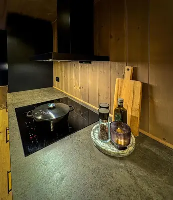 a kitchen with a counter top with a pot and a bottle at Modern cottage in the heart of the Sunnmøre Alps in Sykkylven
