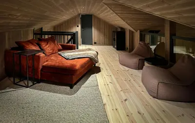 a living room with a couch and two chairs at Modern cottage in the heart of the Sunnmøre Alps in Sykkylven