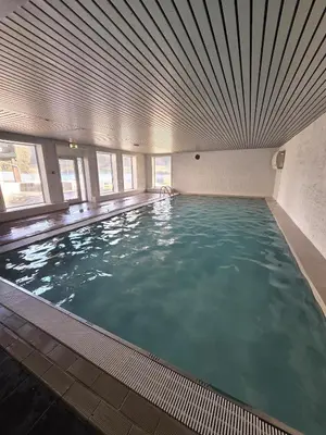 a large swimming pool with a large ceiling at 