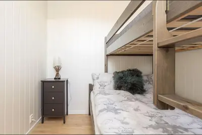 a bedroom with a bunk bed and a night stand at Mountain Dream in Vossevangen