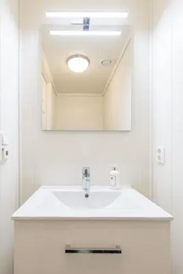 a bathroom with a white sink and a mirror at Mountain Dream in Vossevangen