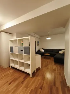 a living room with a white book shelf and a couch at Modern 3-Bedroom Apartment in Central Voss - Prime Location in Vossevangen