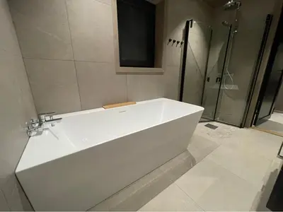 a white bath tub in a bathroom with a shower at Fjellro Budor - ski in ski out in Løten