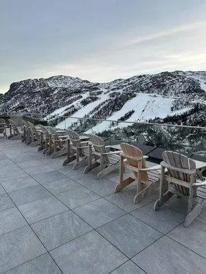 a row of chairs sitting on top of a mountain at Ski in ski out apartment with sauna in Hemsedal