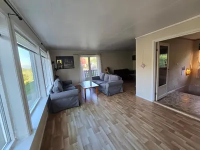 a living room with two couches and a table at Brendefur Panorama in Hornindal