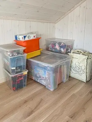 a room with boxes and crates on a wooden floor at Modern Cabin With Views Of Langsua National Park in Etnedal
