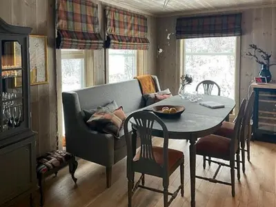 a living room with a table and a couch at Modern Cabin With Views Of Langsua National Park in Etnedal