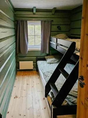 a room with two bunk beds and a window at Family Cabin With Views Towards Solentoppene in Nymoen