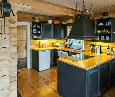 a kitchen with wooden floors and a stove top oven at Family Cabin With Views Towards Solentoppene in Nymoen