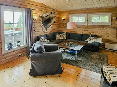 a living room with a couch and a table at Family Cabin With Views Towards Solentoppene in Nymoen