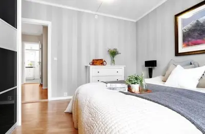 a bedroom with a bed and a dresser at Central, lovely apartment with a unique view in Bergen