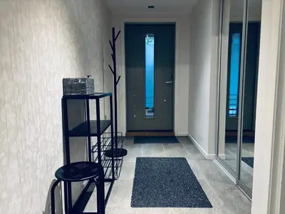 a hallway with two stools and a door in a building at Central Apt - Steps to Fish Market and Bryggen in Bergen