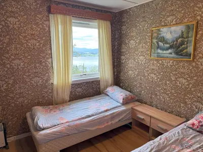 a small room with a window and a small bed at Great House with a panoramic view in Storsæter