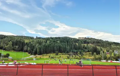 a group of people playing soccer on a tennis court at Awesome Apartment In Ulvik With House Sea View in Ulvik