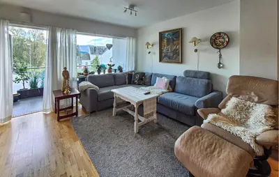 a living room with a couch and a table at Awesome Apartment In Ulvik With House Sea View in Ulvik