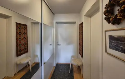 a hallway with two stools and a glass door at Awesome Apartment In Ulvik With House Sea View in Ulvik